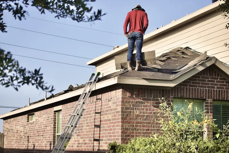 Professional roofer working on a residential roof in Bywood